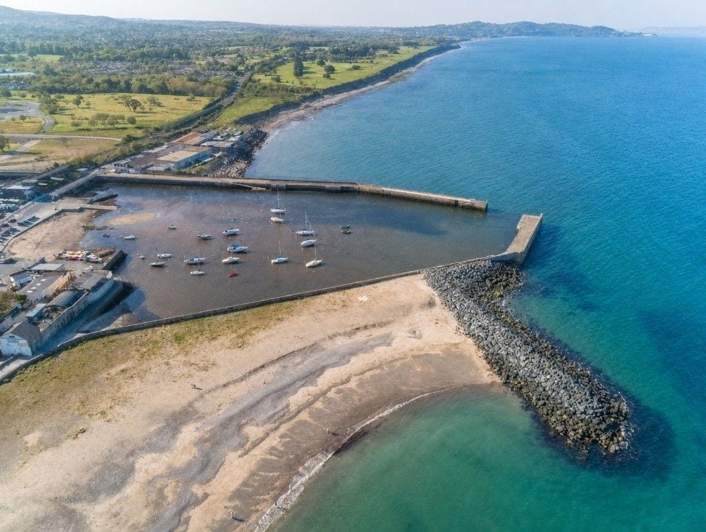 Bray Harbour from the air by day: the drying basin between two piers, looking north.